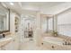Bright bathroom featuring a tub, walk-in shower, vanity and decorative shelving at 805 3Rd E St, Palmetto, FL 34221