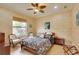 Well-lit bedroom with a patterned bedspread, and comfortable seating at 805 3Rd E St, Palmetto, FL 34221