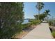 Scenic walking path alongside the water with lush landscaping and palm trees at 805 3Rd E St, Palmetto, FL 34221