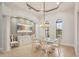Elegant dining room featuring a glass top table, tile floors, and light fixture at 805 3Rd E St, Palmetto, FL 34221