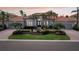 Stunning single-story residence showcasing manicured gardens, a three-car garage, and an inviting front entrance at 805 3Rd E St, Palmetto, FL 34221