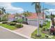 Charming single-story home featuring a brick driveway, well-manicured landscaping, and a three-car garage at 805 3Rd E St, Palmetto, FL 34221