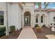 Elegant front entrance features arched doorways, stone accents, and lush landscaping at 805 3Rd E St, Palmetto, FL 34221