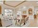 The elegant living room features neutral décor, tray ceiling, tile floors, and a view to the pool area at 805 3Rd E St, Palmetto, FL 34221