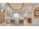 Elegant living room featuring neutral décor, tray ceiling, tile floors, and a view to the pool area at 805 3Rd E St, Palmetto, FL 34221