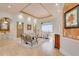 Elegant living room featuring neutral décor, tray ceiling, tile floors, and a view to the pool area at 805 3Rd E St, Palmetto, FL 34221
