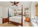 A spacious main bedroom featuring a four-poster bed and a window seat with lots of natural light at 805 3Rd E St, Palmetto, FL 34221