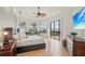 Spacious bedroom with tray ceilings, tile floors, and sliding doors to the outdoors at 805 3Rd E St, Palmetto, FL 34221