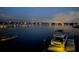 Nighttime harbor view featuring a boat docked next to a lit pier, with city lights reflecting at 805 3Rd E St, Palmetto, FL 34221