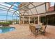 The screened-in patio with outdoor dining, pool, and bar is an entertainer's dream at 805 3Rd E St, Palmetto, FL 34221