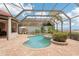 A luxurious screened-in outdoor pool with a spa and a seating area offers a relaxing escape at 805 3Rd E St, Palmetto, FL 34221