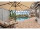 Relax poolside with a chaise lounge in this screened-in lanai featuring a pool and beautiful landscaping at 805 3Rd E St, Palmetto, FL 34221