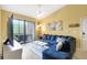 Cozy living room featuring a comfy couch, ceiling fan, and a sliding glass door to the balcony at 8341 38Th Street E Cir # 303, Sarasota, FL 34243