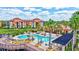 Community swimming pool showcasing ample lounge seating, palm trees, and sunny gathering spaces at 8341 38Th Street E Cir # 303, Sarasota, FL 34243