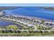 Aerial view of waterfront condominiums showcasing a lakeside community with parking at 920 Tidewater Shores Loop # 304, Bradenton, FL 34208