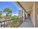 Balcony view of landscaped grounds with palm trees and covered parking areas at 920 Tidewater Shores Loop # 304, Bradenton, FL 34208