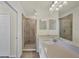 Bathroom featuring a glass shower, stone countertop, and white sink at 920 Tidewater Shores Loop # 304, Bradenton, FL 34208