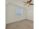 Bedroom with neutral carpet, ceiling fan, and water view at 920 Tidewater Shores Loop # 304, Bradenton, FL 34208