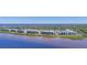 Aerial view of a waterfront condominium community with multiple buildings and water access at 920 Tidewater Shores Loop # 304, Bradenton, FL 34208