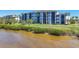 Exterior view of condominium building with waterfront view, featuring screened lanais at 920 Tidewater Shores Loop # 304, Bradenton, FL 34208