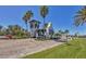 Community entrance with palm trees, white tower, and signage at 920 Tidewater Shores Loop # 304, Bradenton, FL 34208