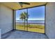 Relaxing screened lanai overlooking the water with a palm tree view at 920 Tidewater Shores Loop # 304, Bradenton, FL 34208