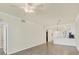 Open living area with neutral walls, tile flooring, and partial kitchen view at 920 Tidewater Shores Loop # 304, Bradenton, FL 34208