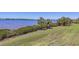 Beautiful waterfront view with lush green lawn sloping toward the calm water at 920 Tidewater Shores Loop # 304, Bradenton, FL 34208