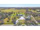Sprawling estate with a long driveway, a beautiful pond, a large home, and plenty of green space surrounded by a white fence at 9902 284Th St E E St, Myakka City, FL 34251
