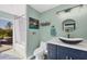 Charming bathroom features modern vanity, walk-in shower and access to outdoor patio at 9902 284Th St E E St, Myakka City, FL 34251