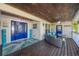 Cozy front porch with comfortable seating, blue accents, and a ceiling fan for enjoying pleasant outdoor moments at 9902 284Th St E E St, Myakka City, FL 34251