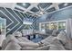 Beautiful living room with coffered ceilings, patterned accent wall, and comfortable seating arrangement at 9902 284Th St E E St, Myakka City, FL 34251