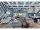 Elegant living room with coffered ceilings, modern decor, and an open floor plan seamlessly connecting living spaces at 9902 284Th St E E St, Myakka City, FL 34251