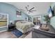 Spacious main bedroom with fan, sitting area, and access to outdoor space at 9902 284Th St E E St, Myakka City, FL 34251