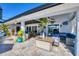 Inviting outdoor patio area with stylish seating, ceiling fan, and tropical decor at 9902 284Th St E E St, Myakka City, FL 34251