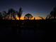 Captivating sunset casting beautiful colors across the sky as seen from the property's pool area at 9902 284Th St E E St, Myakka City, FL 34251
