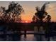 Relaxing poolside view at sunset, with patio seating and vibrant colors creating a serene and peaceful atmosphere at 9902 284Th St E E St, Myakka City, FL 34251