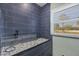 Relaxing shower showcasing modern tiles, glass door, and a window providing natural light at 9902 284Th St E E St, Myakka City, FL 34251