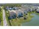 Aerial view of the back of a home overlooking a pond, featuring a fenced backyard and outdoor seating at 108 San Avellino Ct, Bradenton, FL 34208