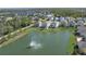 Aerial view of a pond with fountain surrounded by homes and landscaping within a community at 108 San Avellino Ct, Bradenton, FL 34208