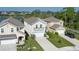 Aerial view of a two-story home, neighboring houses, lawn, and a glimpse of the nearby lake at 108 San Avellino Ct, Bradenton, FL 34208