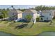 Backyard view with manicured lawns and fenced boundary with pond view at 108 San Avellino Ct, Bradenton, FL 34208