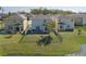 Aerial view of a fenced backyard with a small pond in the background and an outdoor table and chairs at 108 San Avellino Ct, Bradenton, FL 34208