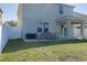The backyard features green lawn with a patio and outdoor dining set at 108 San Avellino Ct, Bradenton, FL 34208