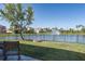 Landscaped backyard with fire pit and expansive lake view featuring a fountain at 108 San Avellino Ct, Bradenton, FL 34208
