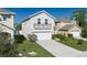 View of the home showcasing the front lawn, driveway and landscaping features at 108 San Avellino Ct, Bradenton, FL 34208
