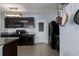 Charming kitchen featuring dark cabinets, granite countertops, and modern appliances at 108 San Avellino Ct, Bradenton, FL 34208