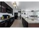 Spacious kitchen featuring granite countertops, black appliances, and an island with a sink at 108 San Avellino Ct, Bradenton, FL 34208