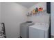 Efficient laundry room featuring a washer, dryer, shelving, and ample storage space at 108 San Avellino Ct, Bradenton, FL 34208