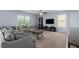 Cozy living room with a comfortable seating area, entertainment center, and lots of natural light at 108 San Avellino Ct, Bradenton, FL 34208
